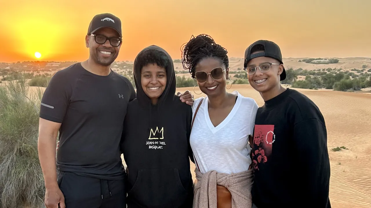 Demond family of four on beachfront at sunset